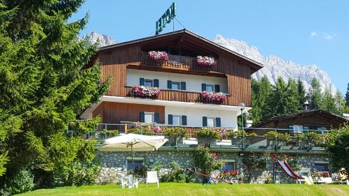 a large house with a view of the ocean at Hotel Villa Gaia in Cortina dʼAmpezzo