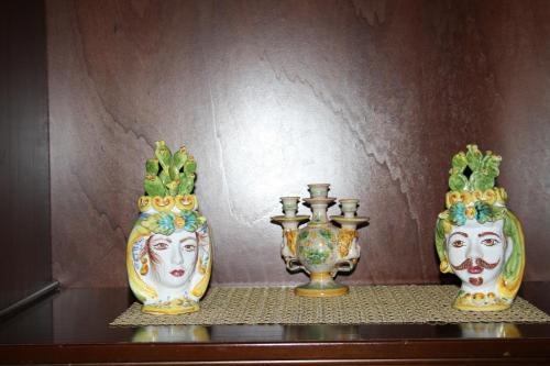 three vases sitting on a shelf next to a wall at Da Lorenzo Apartment in Gaggi