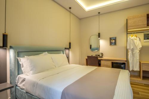 a bedroom with a large bed and a sink at Philia Boutique Hotel in Athens