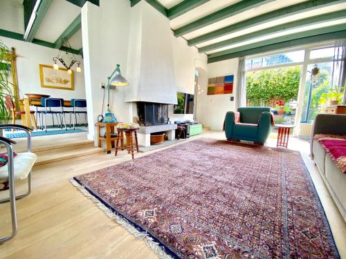 a living room with a couch and a fireplace at The New Fisherman’s House in Zandvoort