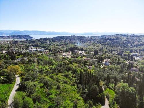 an aerial view of a city with trees at Mansion on the Hill by CorfuEscapes in Virós