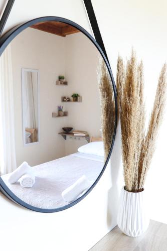 a round mirror in a bedroom with a bed at Mansion on the Hill by CorfuEscapes in Virós