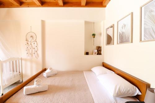 a white bedroom with a bed and a crib at Mansion on the Hill by CorfuEscapes in Virós