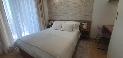 Posteľ alebo postele v izbe v ubytovaní Apartments Elite