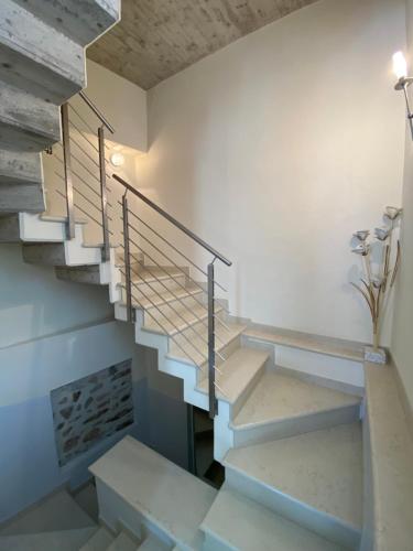 a staircase in a house with white walls and concrete floors at Appartamenti Mavino in Sirmione