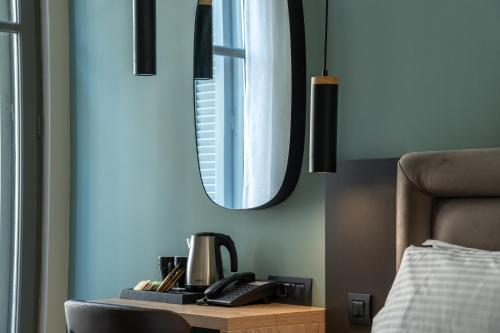 a table with a coffee maker and a mirror at Philia Boutique Hotel in Athens