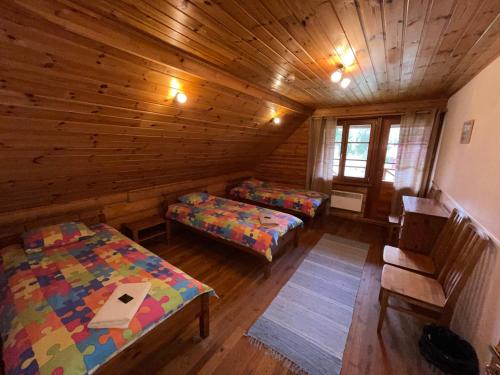 a room with two beds in a log cabin at Jaunsētas in Alūksne