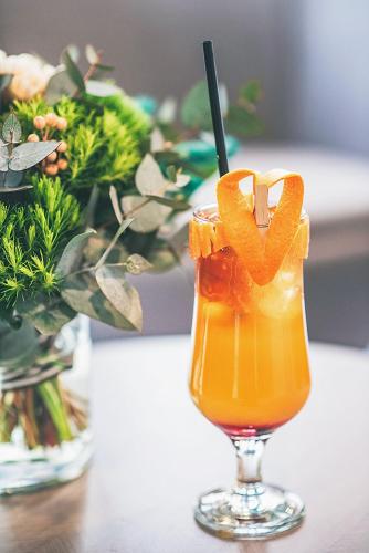 a glass of orange juice with a stick in it at Meta Business Hotel By King David in Tbilisi City