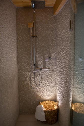 a bathroom with a shower with a basket in the corner at Pnoes Villas Vasiliki Lefkada in Vasiliki