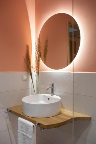 a bathroom with a sink and a mirror at Pnoes Villas Vasiliki Lefkada in Vasiliki