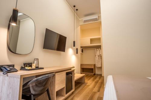 a room with a desk with a television and a mirror at Philia Boutique Hotel in Athens