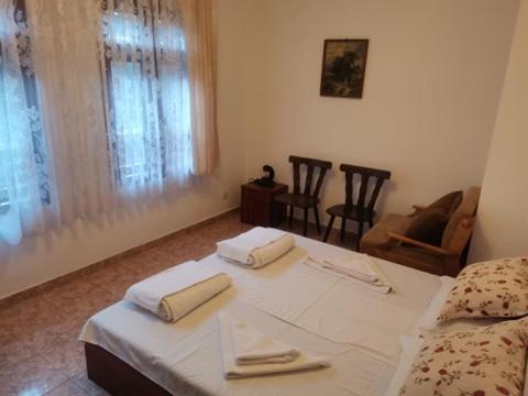 a bedroom with a bed and a table and chairs at Guest House Neli in Nesebar