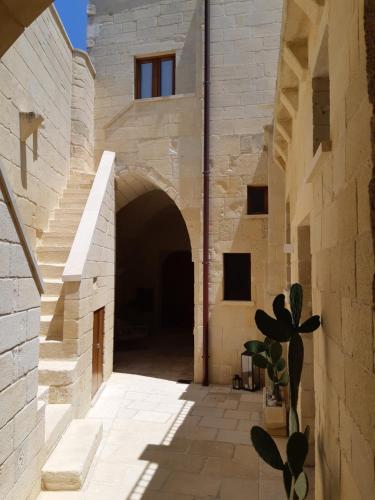 an alley in a stone building with a tunnel at Corte Kalìnora in Martano