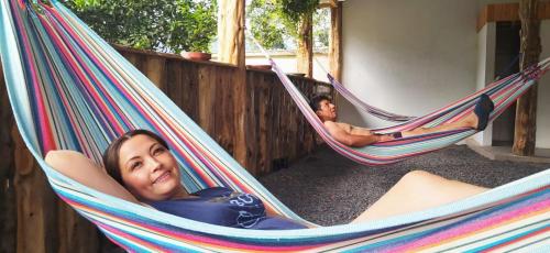 a couple of people laying in hammocks at Casa del Peregrino Santo Thomas in Baños