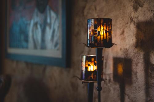 two lights on a wall in a room at Hotel Keto in Podgorica