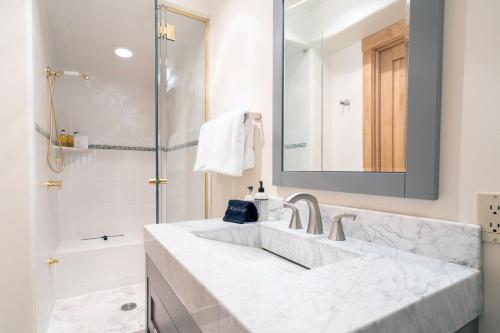 a white bathroom with a sink and a shower at Ballard South in Telluride