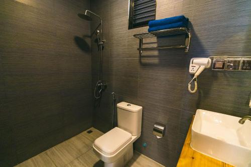 a bathroom with a toilet and a sink at Endheri Sunset Dhangethi in Dhangethi