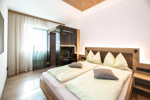 a bedroom with a large bed with pillows on it at Huebenburg in Appiano sulla Strada del Vino