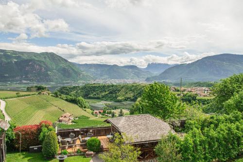 an estate in the mountains with mountains in the background at Huebenburg in Appiano sulla Strada del Vino