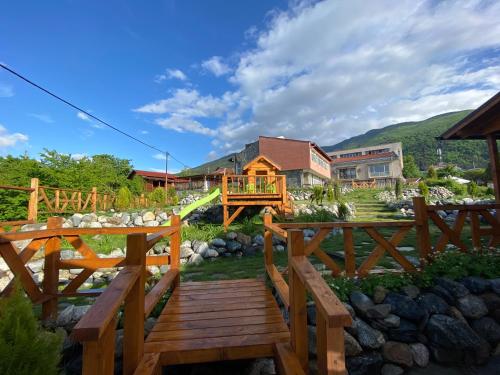 a wooden bridge in a yard with a house at Тихият кът in Sapareva Banya