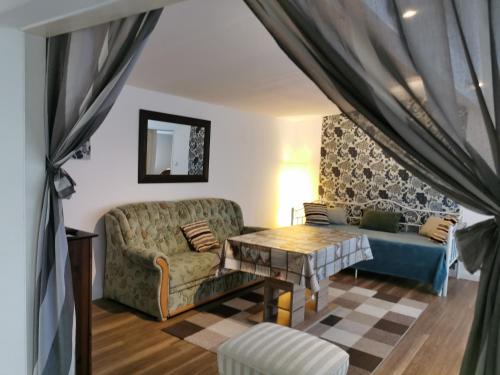 a living room with a couch and a table at Finnenhaus in Neumünster