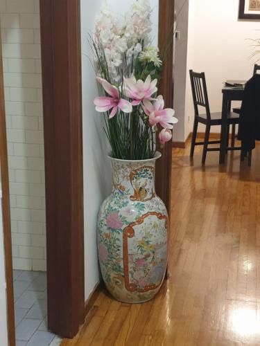 a vase with flowers in it sitting on the floor at Il Posto Giusto in Ciampino