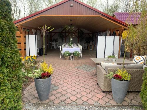 a patio with a table and chairs in a pavilion at Agro na Wapniarni in Białla