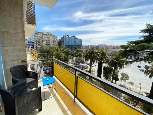 a balcony with a view of the beach and palm trees at BARI ROOMS Suite Station in Bari