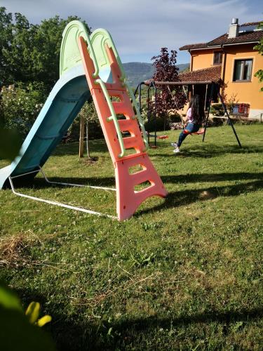 a playground with a slide in a yard at Appartamento/ mansarda nel cuore del Pollino in Viggianello