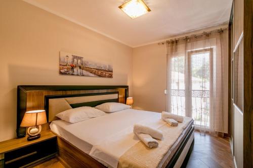 a bedroom with a bed with two towels on it at Apartmani Matej in Kotor