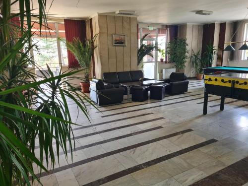 a lobby with couches and a pool table at Туристически дом Кайлъка in Pleven