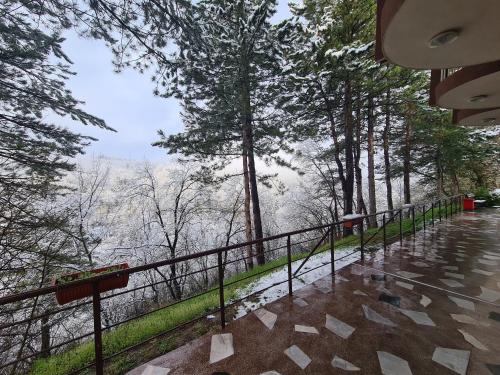 a balcony with a view of a river and trees at Туристически дом Кайлъка in Pleven