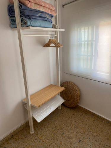 a closet with a wooden shelf in a room at Duplex Casco Histórico in Pontevedra