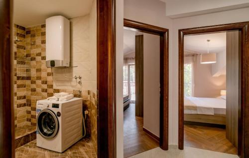 a washer and dryer in a room with a bedroom at Apartmani Matej in Kotor