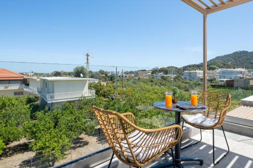 a patio with a table and chairs on a balcony at L & C Boutique Apartments in Kremasti