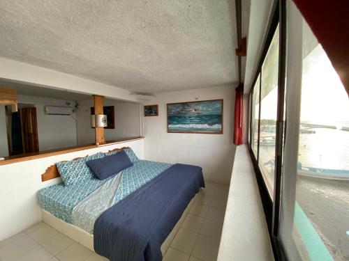 Postel nebo postele na pokoji v ubytování Hotel San Felipe de Jesus Yucatan