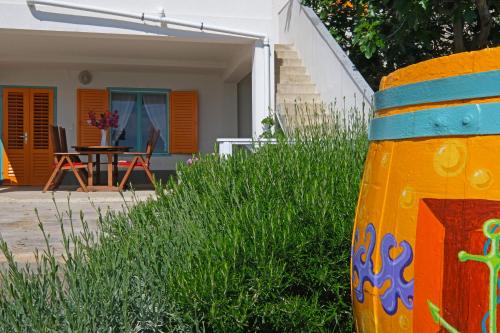 a house with a colorful object in the grass at The View Stara Baška in Stara Baška