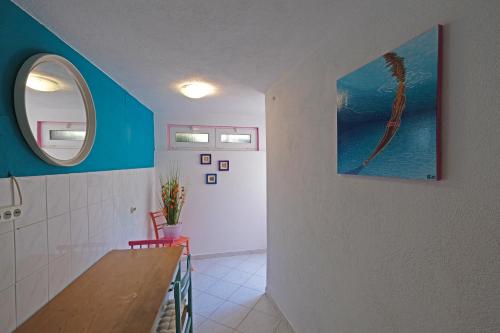 a hallway with a table and a window in a room at The View Stara Baška in Stara Baška