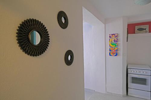 a room with three mirrors on the wall at The View Stara Baška in Stara Baška