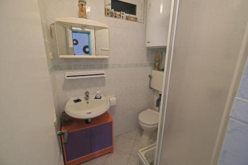 a small bathroom with a sink and a toilet at The View Stara Baška in Stara Baška