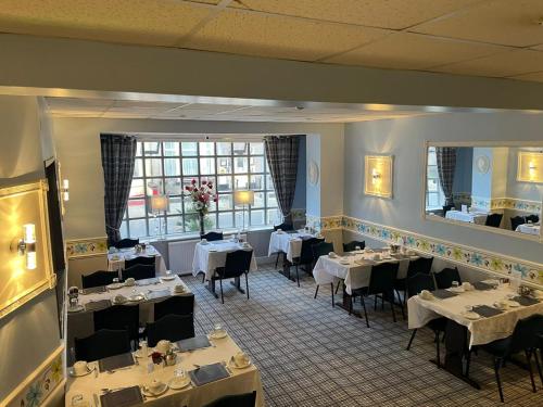 a dining room with tables and chairs in a restaurant at The Boyce Hotel in Blackpool