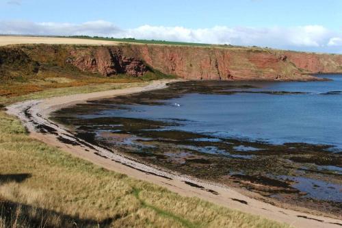 an aerial view of a beach next to the ocean at BELL ROCK VIEW ARBROATH in Angus