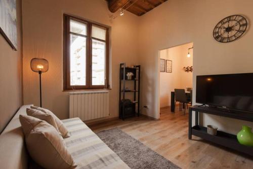 a living room with a couch and a television at Casa Luce - cosy and trendy flat in San Giovanni Valdarno