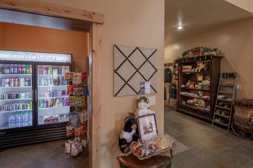 a store with a refrigerator and stuffed animals on the wall at Cowboy Village Resort in Jackson