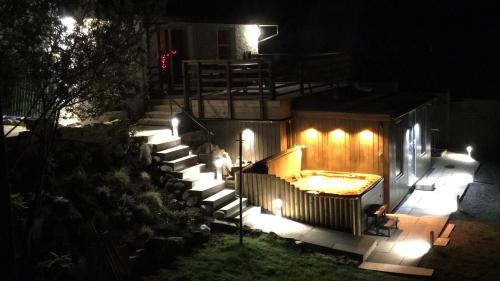 a set of stairs with lights at night at Stunning country home with Hot Tub and Sauna in Strachur