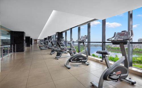 a row of exercise bikes in a building with windows at Crowne Plaza Huangshan Yucheng by IHG in Huangshan