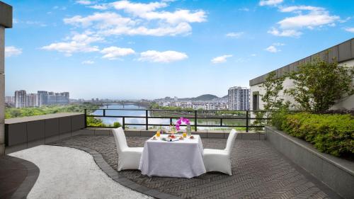 a patio with a table and chairs on a balcony at Crowne Plaza Huangshan Yucheng by IHG in Huangshan