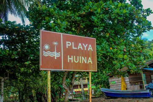 a sign that says playa humima in front of a tree at Refugio Mr Jerry Eco House in Bahía Solano