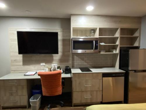 a kitchen with a sink and a microwave at Ramada by Wyndham Medicine Hat in Medicine Hat