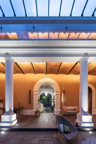 a lobby with a skylight and columns in a building at Hacienda Peña Pobre in Mexico City
